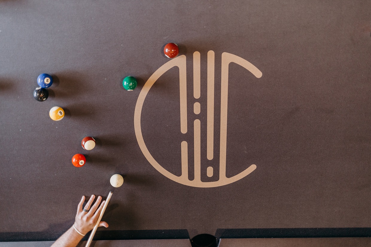 a person playing a game of billiards with colored balls on the table