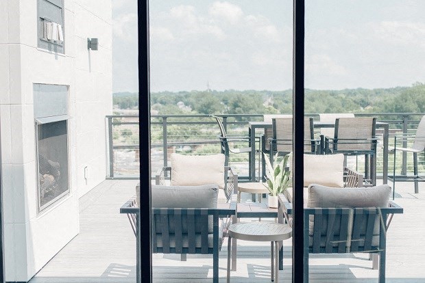 a balcony with a table and chairs and a fireplace