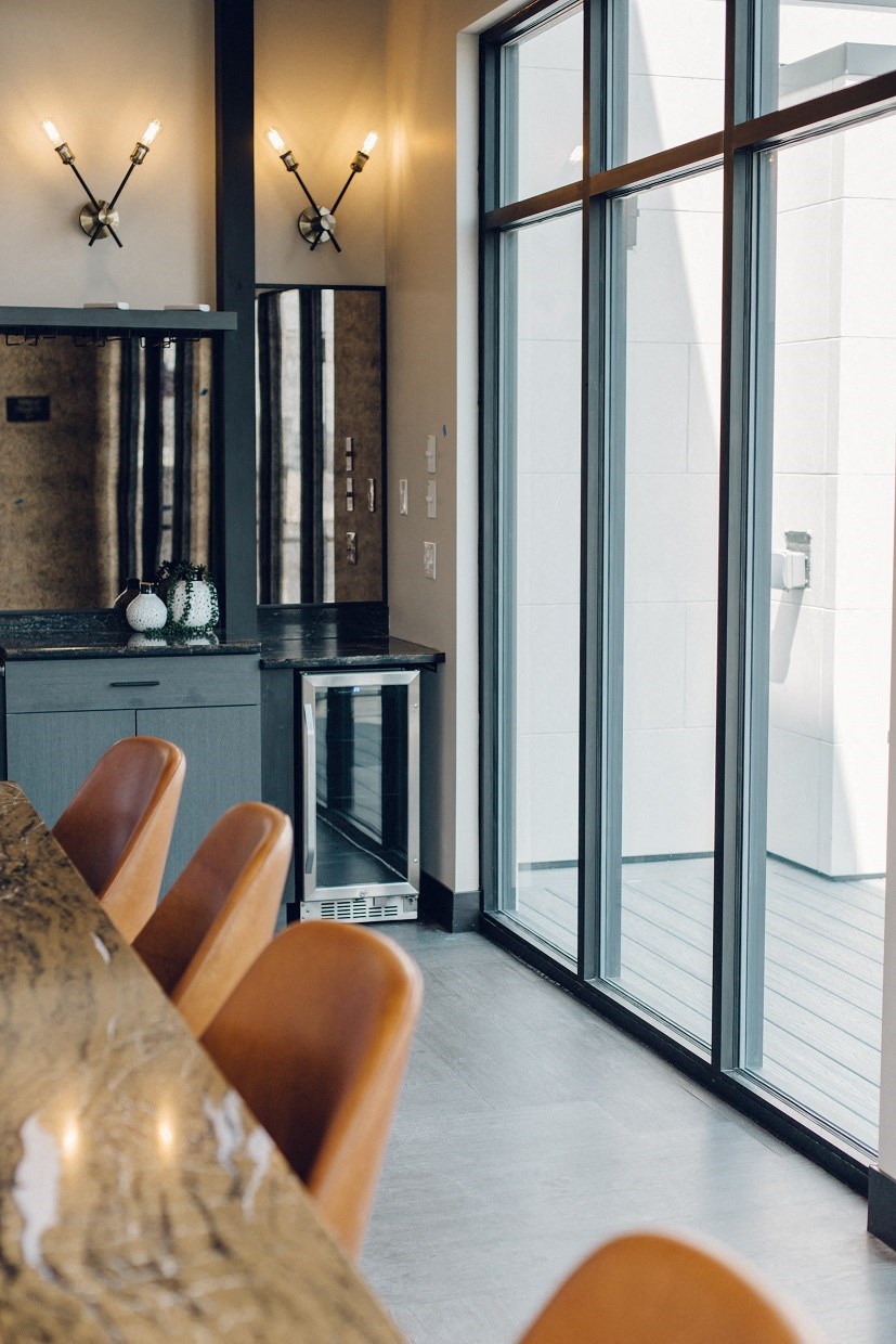 a dining room with glass doors and a table and chairs