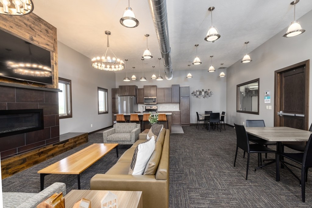 A modern living room with a fireplace and a dining area.