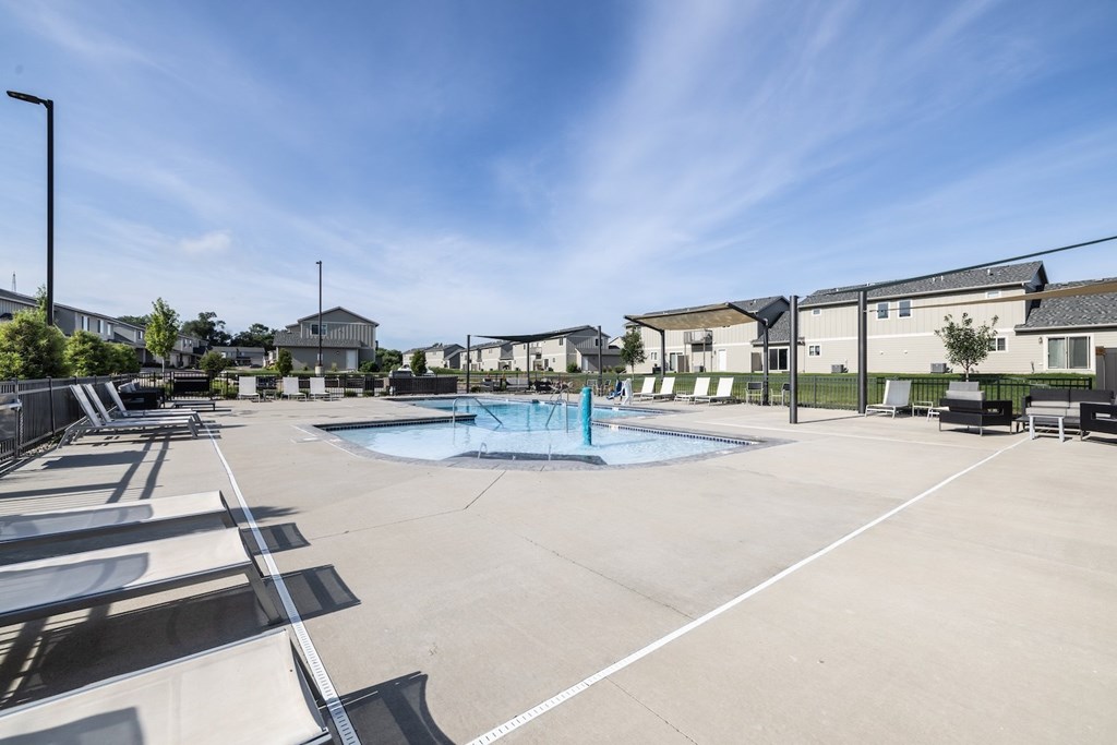 A sunny day at the outdoor pool area of a residential complex.