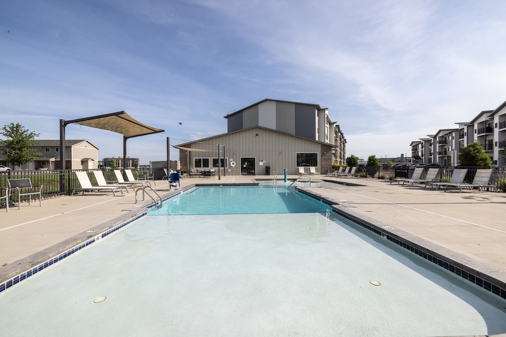 A large swimming pool in a sunny outdoor setting.