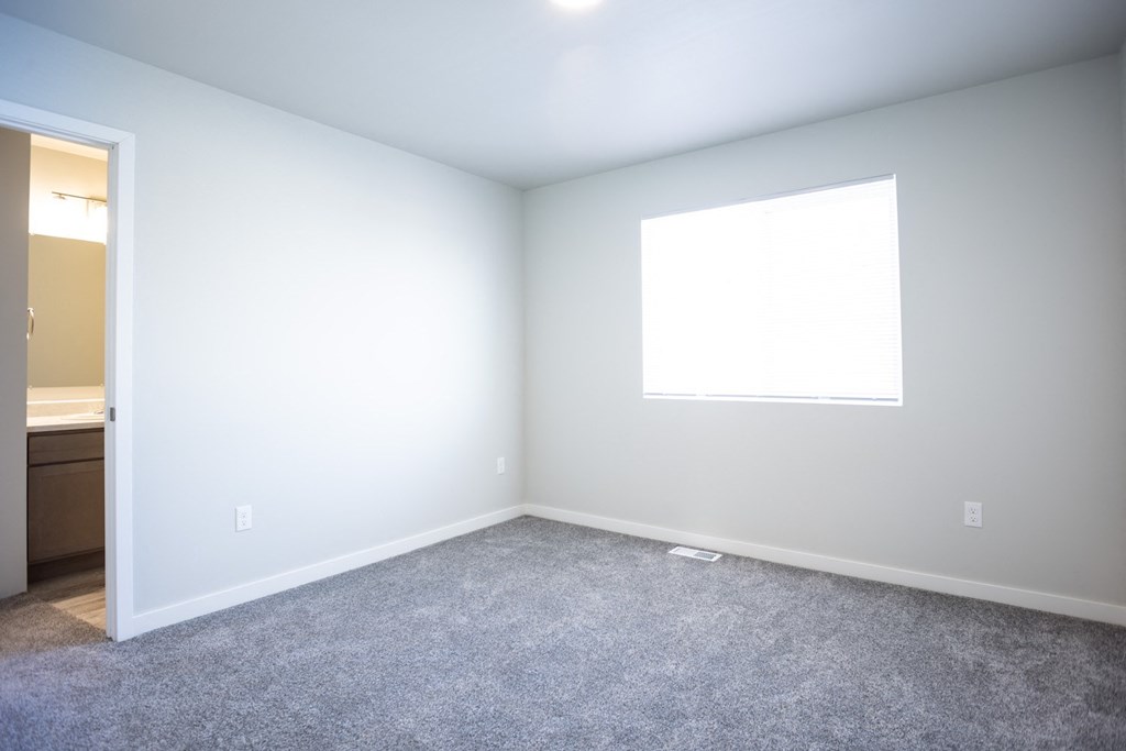an empty room with white walls and a window