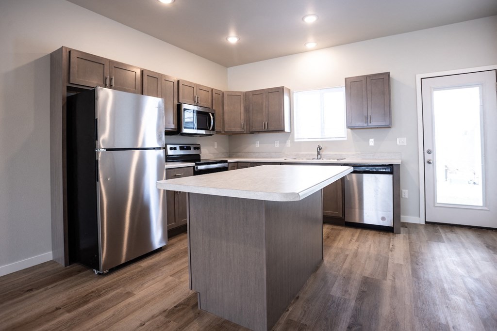 a kitchen with stainless steel appliances and a white counter top