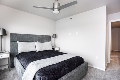 a bedroom with a bed and a ceiling fan