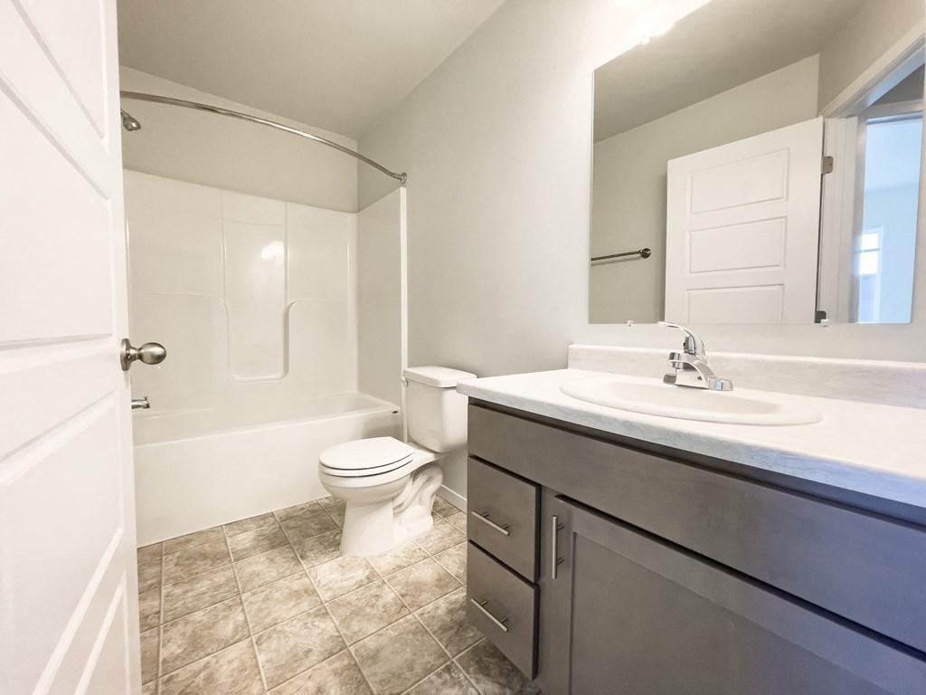 an empty bathroom with a toilet and a sink