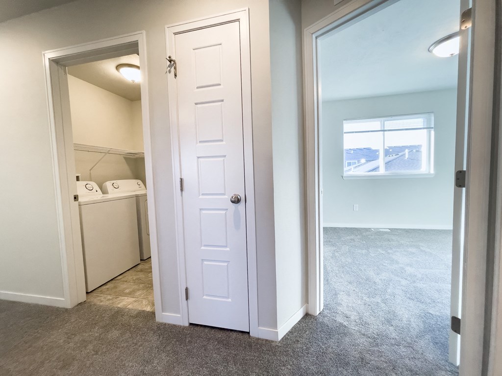 an empty room with a closet and a laundry room