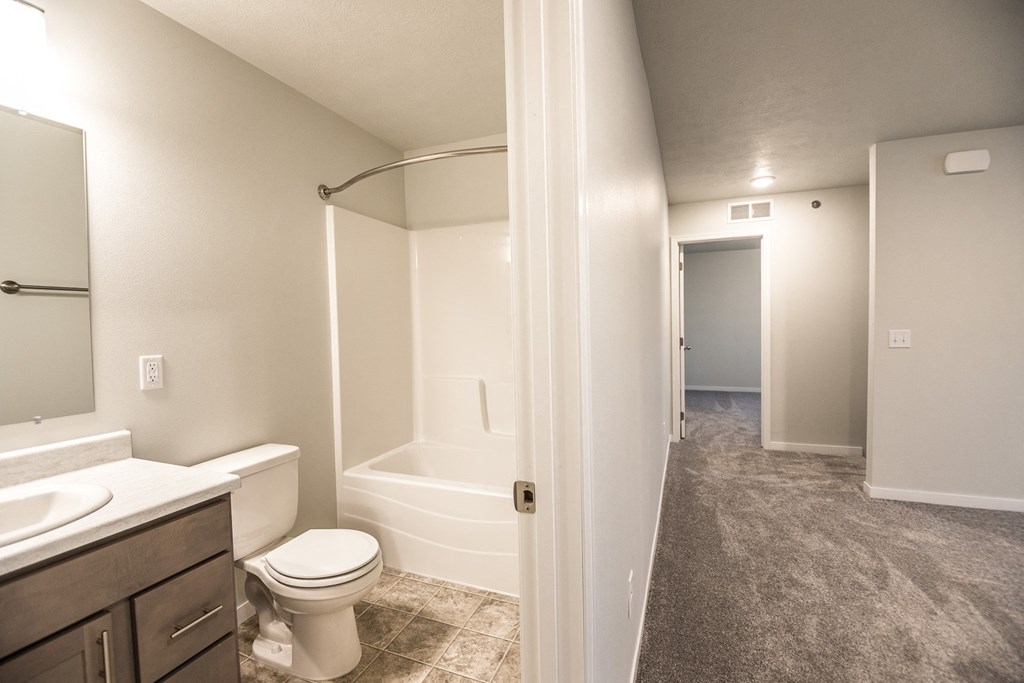 an empty bathroom with a toilet and a shower