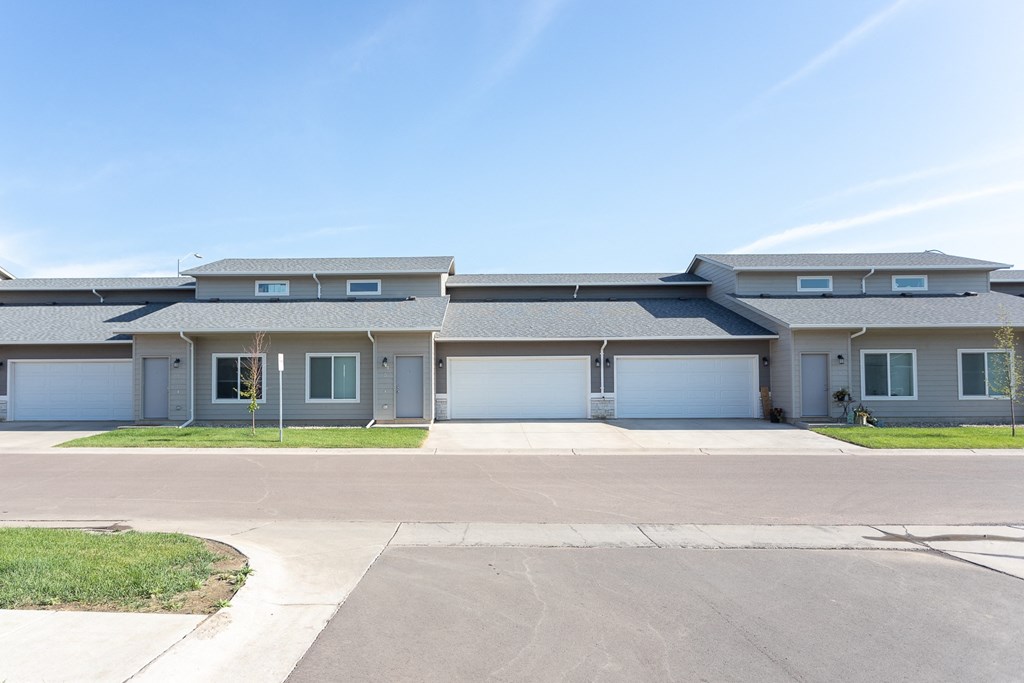 a large house with blue doors and a blue sky