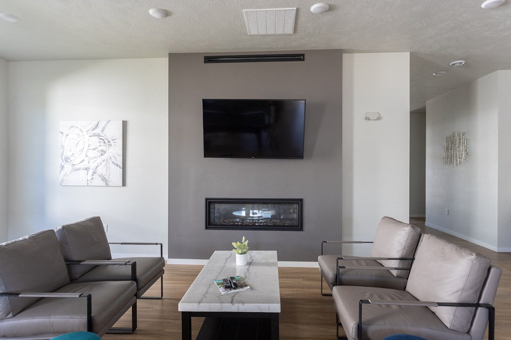 a living room with couches a coffee table and a television