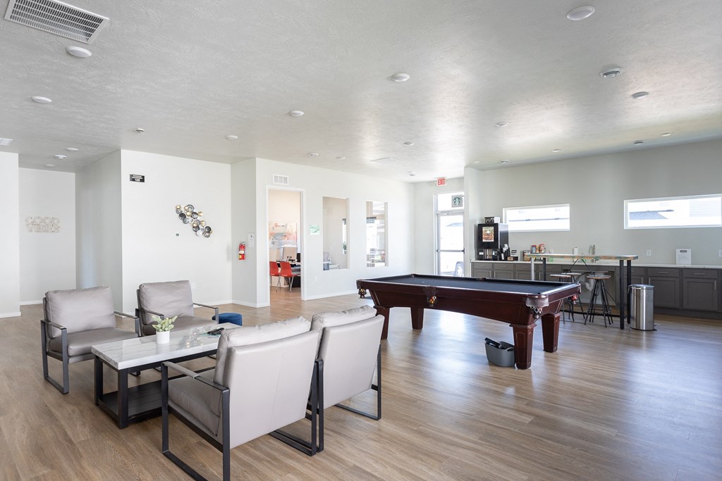 a living room with a pool table and a dining room
