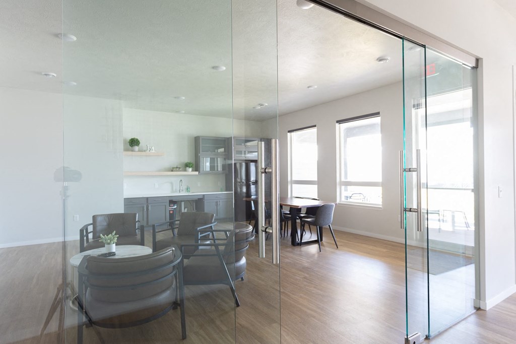 a conference room with glass walls and a table and chairs