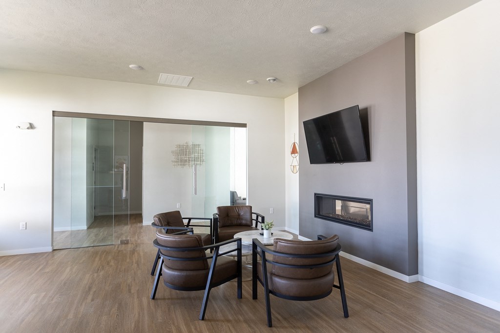 a living room with a table and chairs and a fireplace