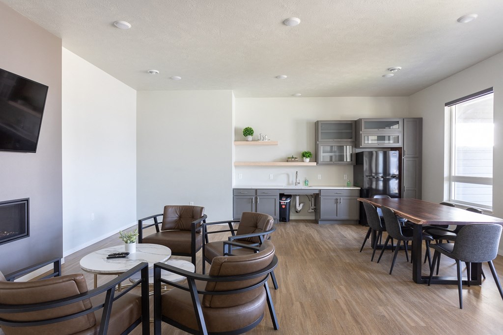 a living room and kitchen with a dining table and chairs