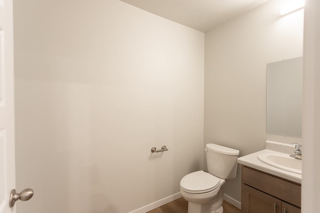 a bathroom with a toilet and a sink and a mirror
