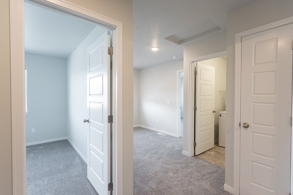 a bedroom with two closets and a door to a bathroom