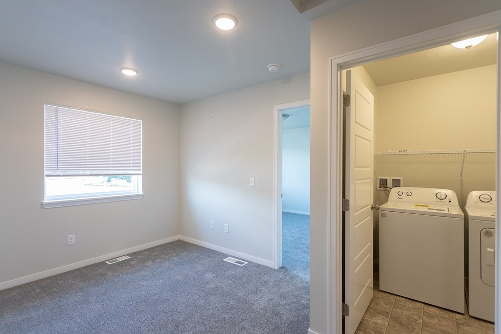 a laundry room with a washer and dryer and a window