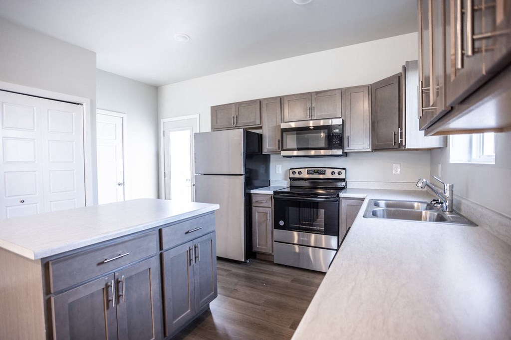 a kitchen with stainless steel appliances and wooden cabinets