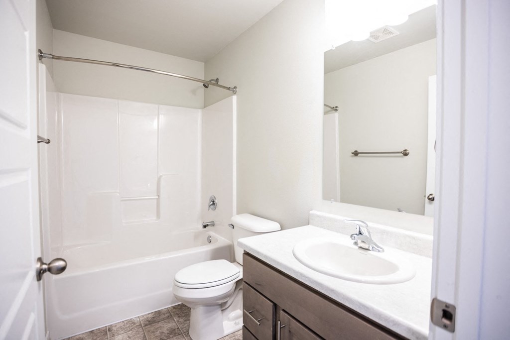 a bathroom with a sink toilet and a mirror