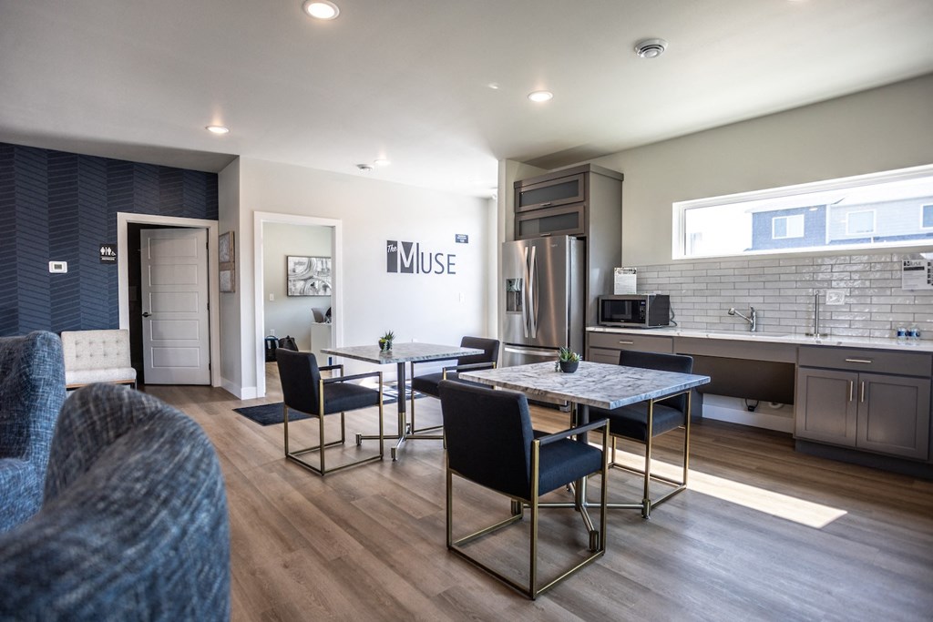 a kitchen and dining room with a table and chairs