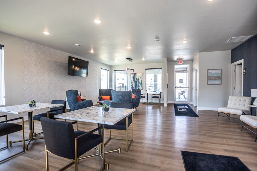 a conference room with tables and chairs and a television