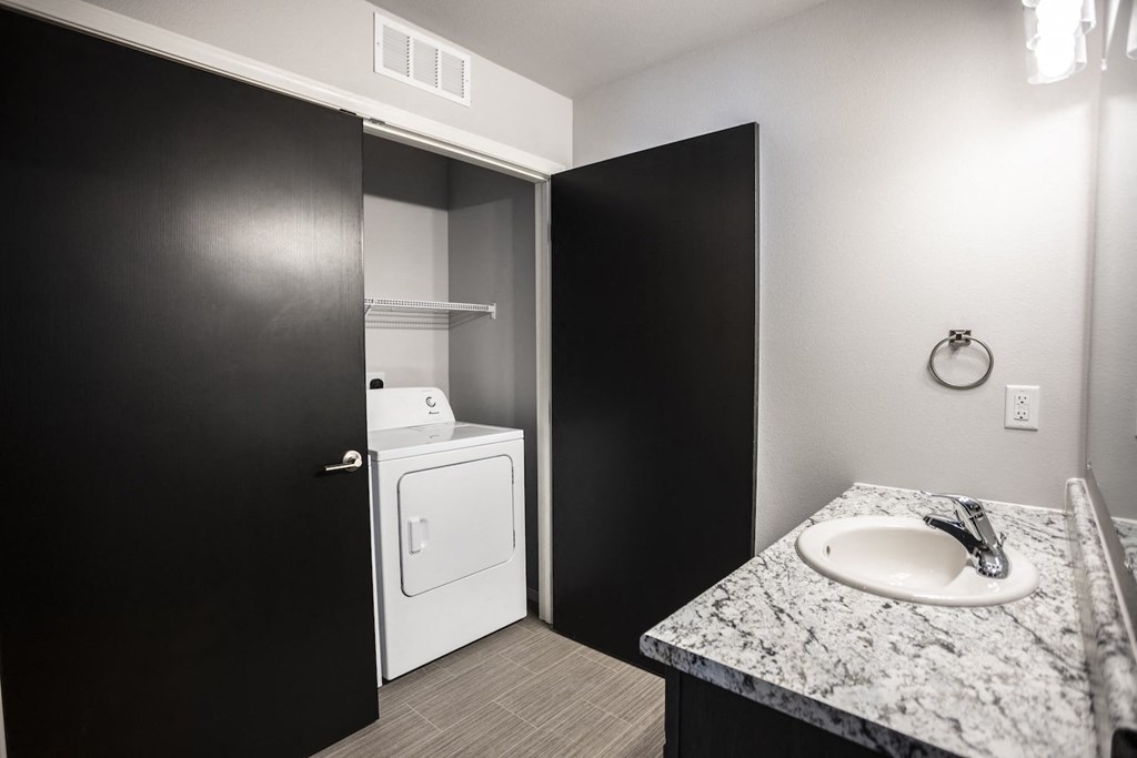 Laundry room with washer and dryer, and built-in cabinets.