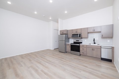 A kitchen with wooden floors and stainless steel appliances.