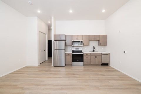 A kitchen with wooden floors and white walls.