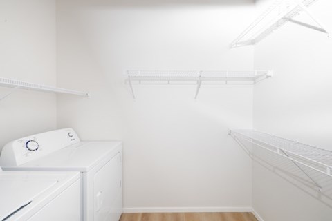 A white laundry room with a washer and dryer.
