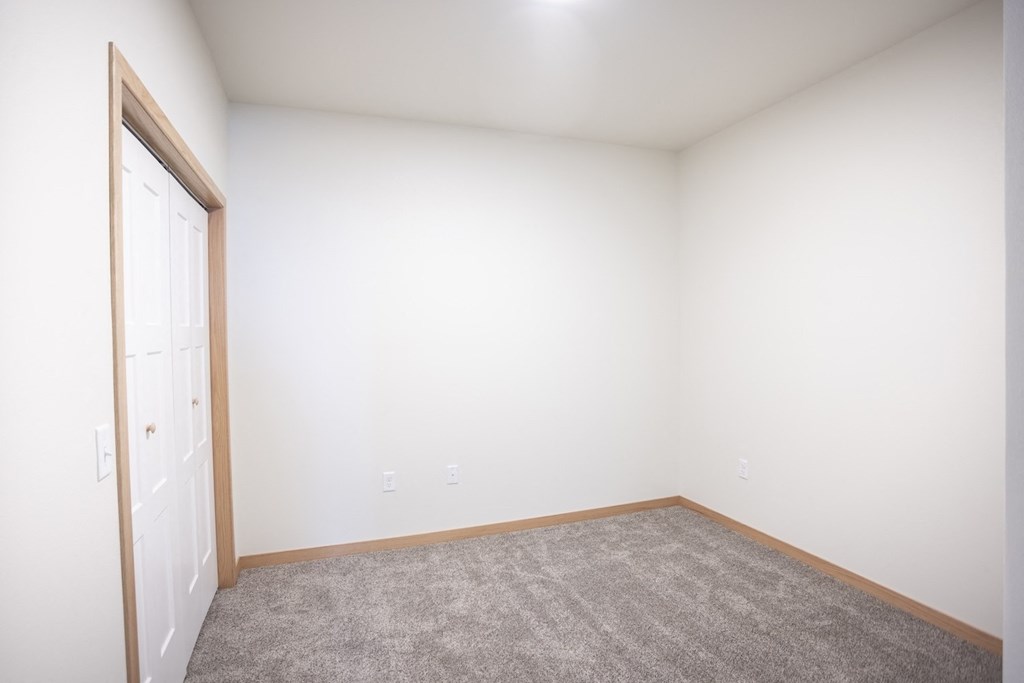 an empty room with carpet and a door