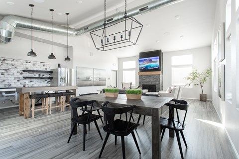 a large dining room with a wooden table and black chairs