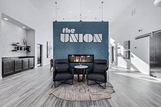 a living room with a fireplace and a blue wall with the union