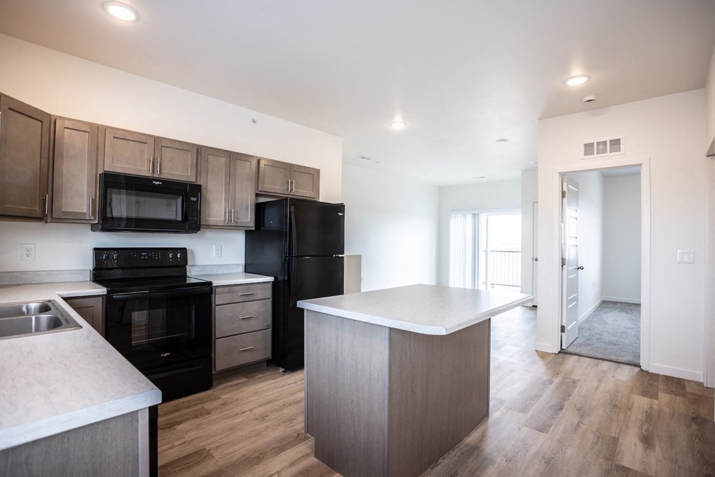 a kitchen with black appliances and a white counter top