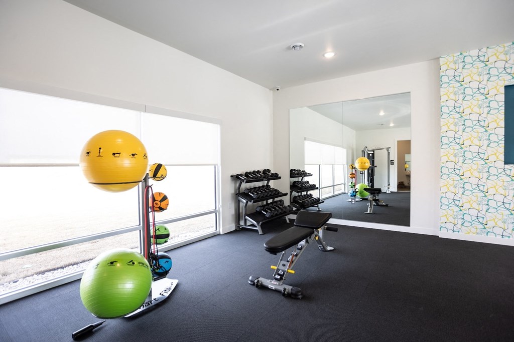 a gym with a view of the water in a condominium