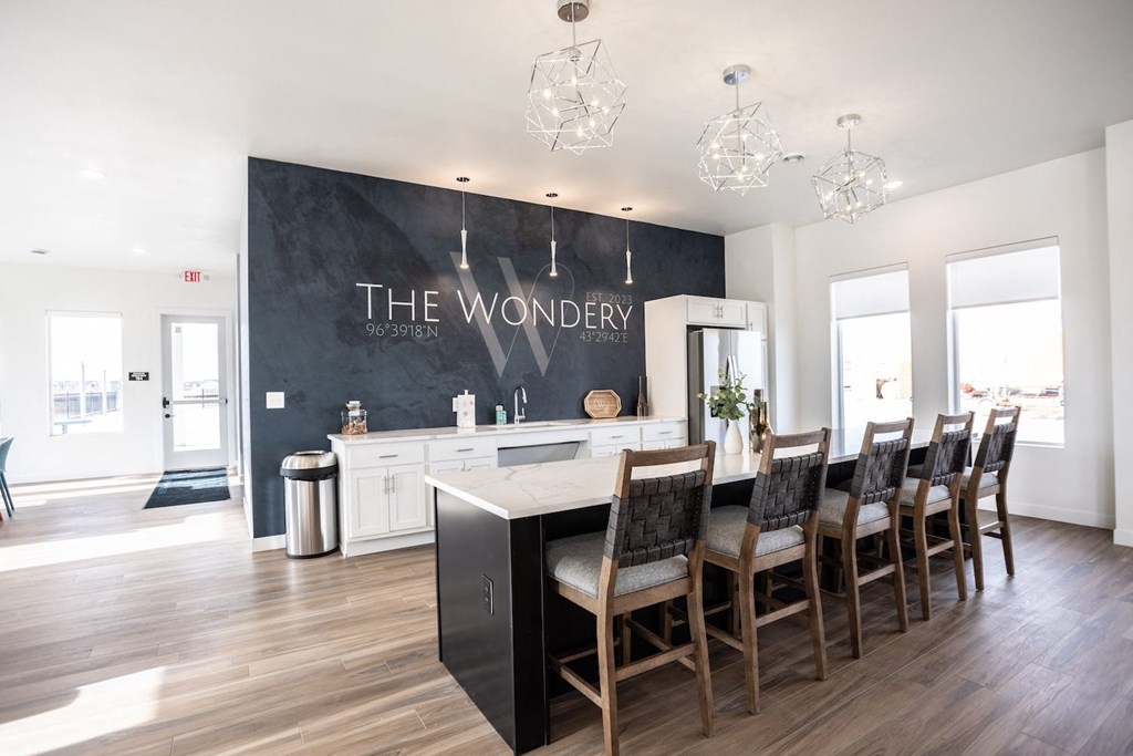 a dining room with a table and chairs in front of a large chalkboard wall
