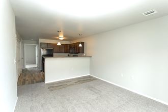 an empty living room and kitchen in a new home