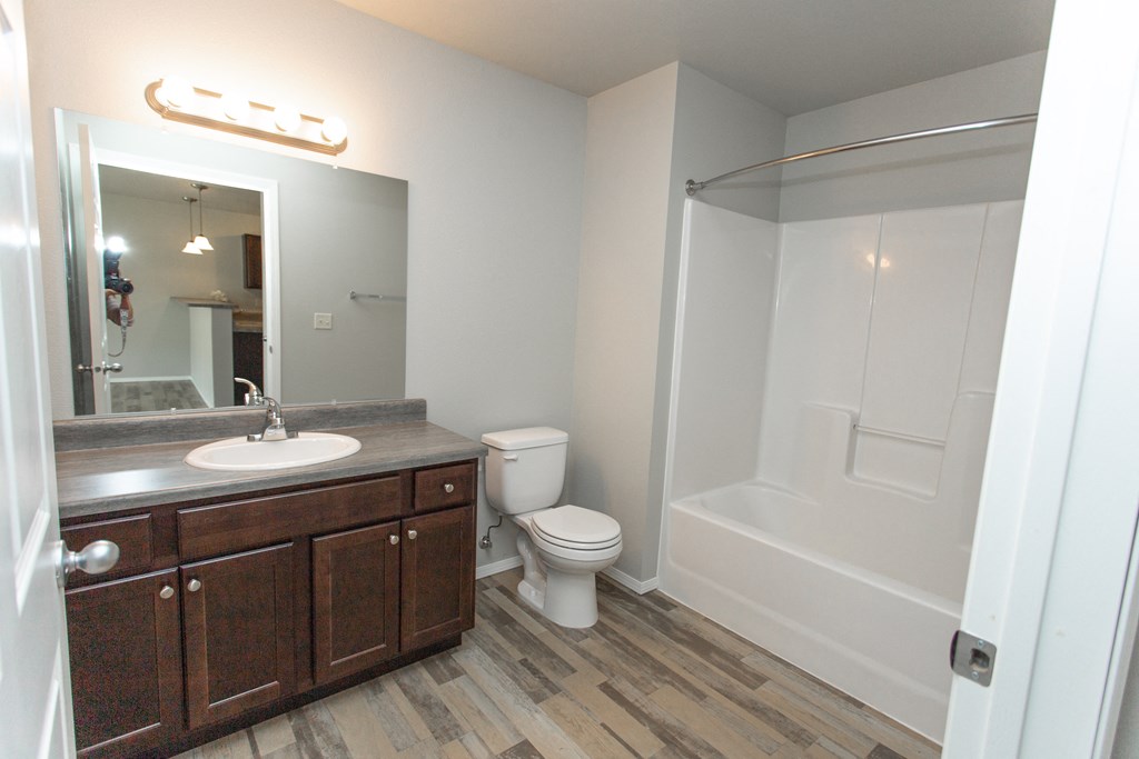 an empty bathroom with a sink toilet and shower