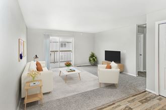 a living room with white couches and a television