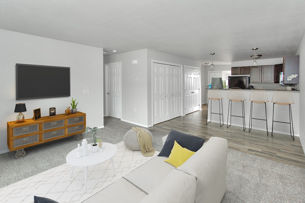 a living room with a white couch and a television