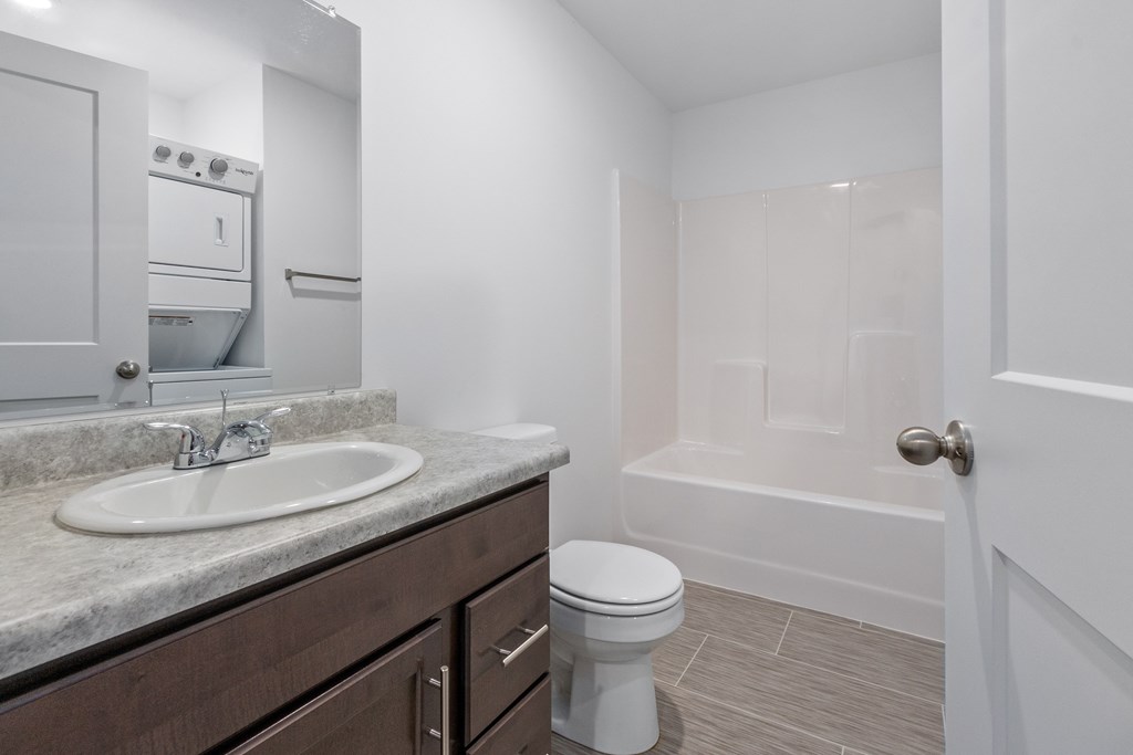A white bathroom with a sink, toilet, and bathtub.