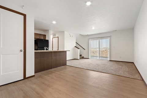 A living room with a white door and a brown cabinet.