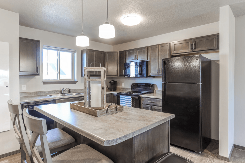a kitchen with stainless steel appliances and a marble counter top