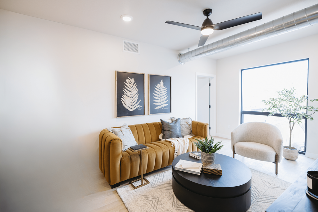 a living room with a brown couch and a coffee table