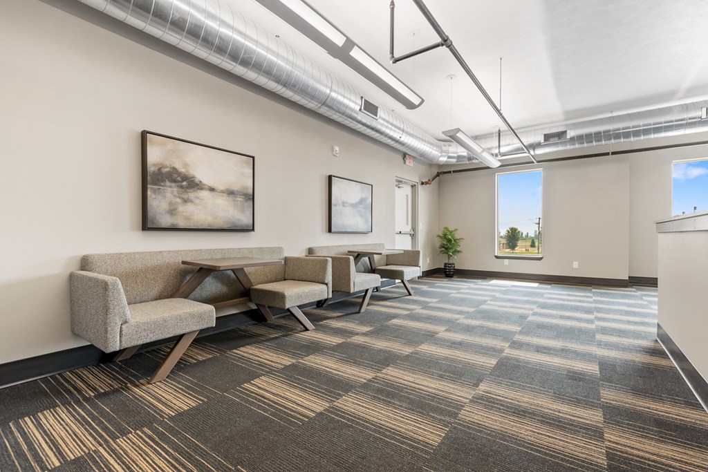 A room with a carpeted floor and a couch.