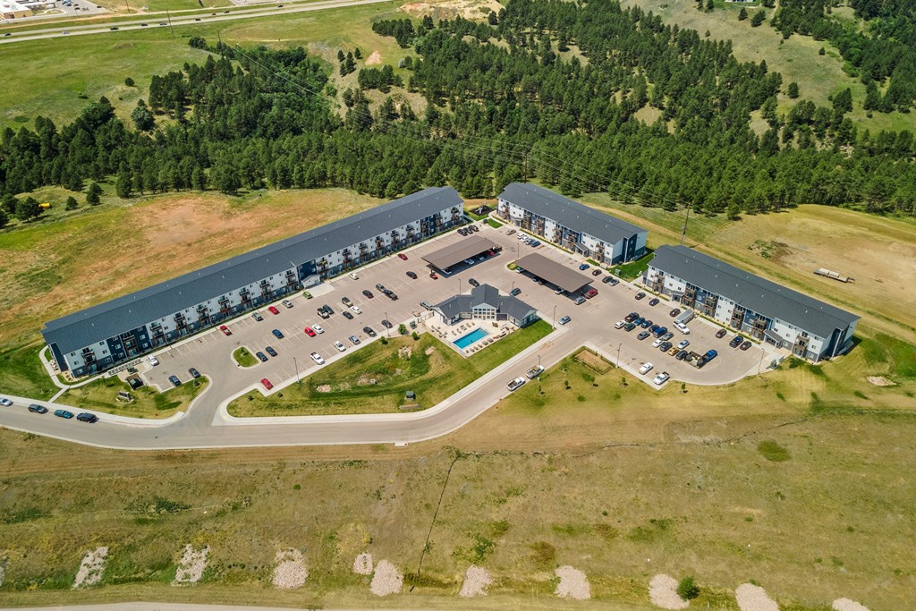 an aerial view of a parking lot and a building