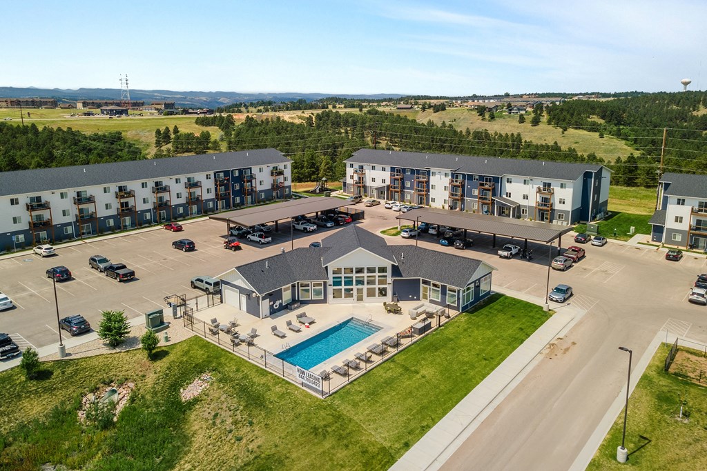 an aerial view of an apartment building with a swimming pool