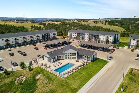 an aerial view of an apartment building with a swimming pool