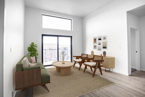 a living room with a table and chairs and a window