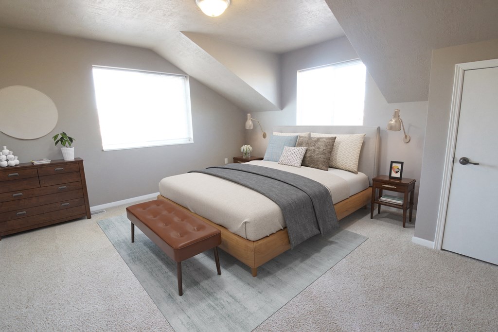 a bedroom with a bed and a dresser and a window