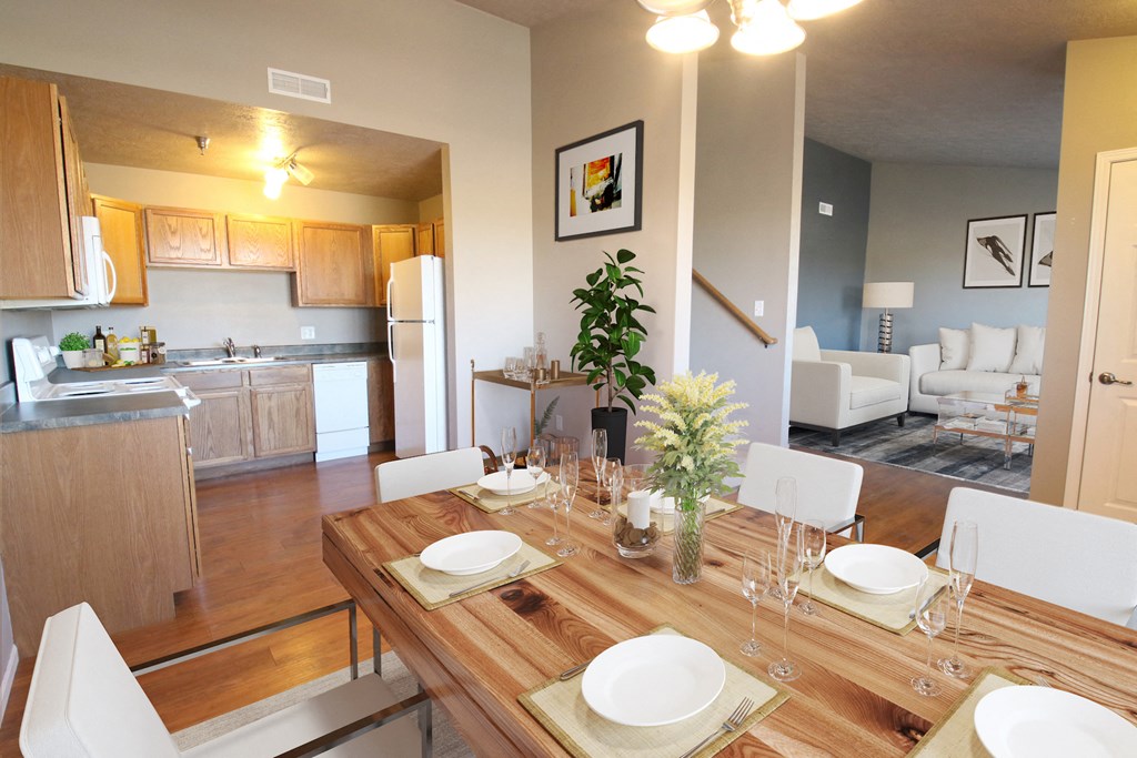a dining room and living room with a table and chairs
